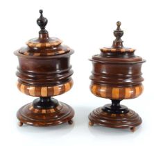 A pair of late 19th/early 20th century specimen urns and covers on bun feet, h. 27 cm One lacking