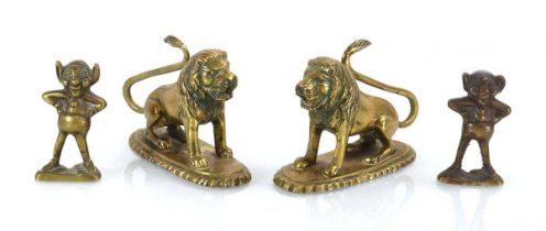 A pair of brass seated lions, w. 11 cm, together with a pair of laughing figures (4)