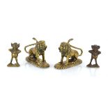 A pair of brass seated lions, w. 11 cm, together with a pair of laughing figures (4)