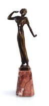 A brown patinated figure modelled as an Art Deco dancer, on a marble column plinth, h. 27 cm