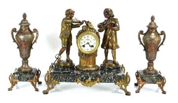 A late 19th/early 20th century mantle clock, the movement within a brass case flanked by a pair of