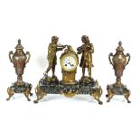 A late 19th/early 20th century mantle clock, the movement within a brass case flanked by a pair of