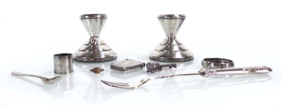 A mixed group of silver comprising a pair of dwarf candlesticks, a napkin ring, a vesta case, a