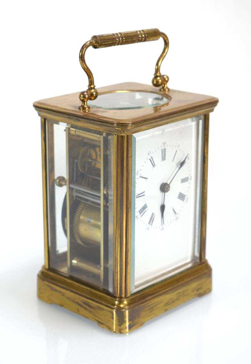 A late 19th/early 20th century carriage clock, the movement striking on a gong, within a brass and