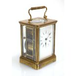 A late 19th/early 20th century carriage clock, the movement striking on a gong, within a brass and