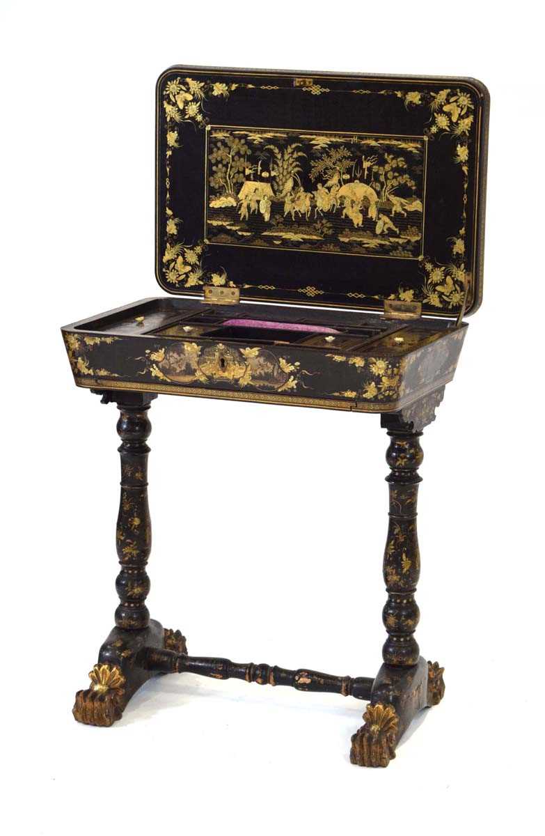 A mid-19th century black lacquered and gilt sewing table intricately decorated in the chinoiserie