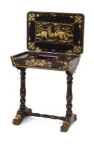 A mid-19th century black lacquered and gilt sewing table intricately decorated in the chinoiserie