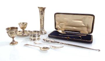 A mixed group of silver comprising two eggcups, a napkin ring, a spill vase, a button hook, a