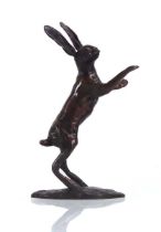 A contemporary bronzed figure modelled as a leaping hare, h. 14.5 cm
