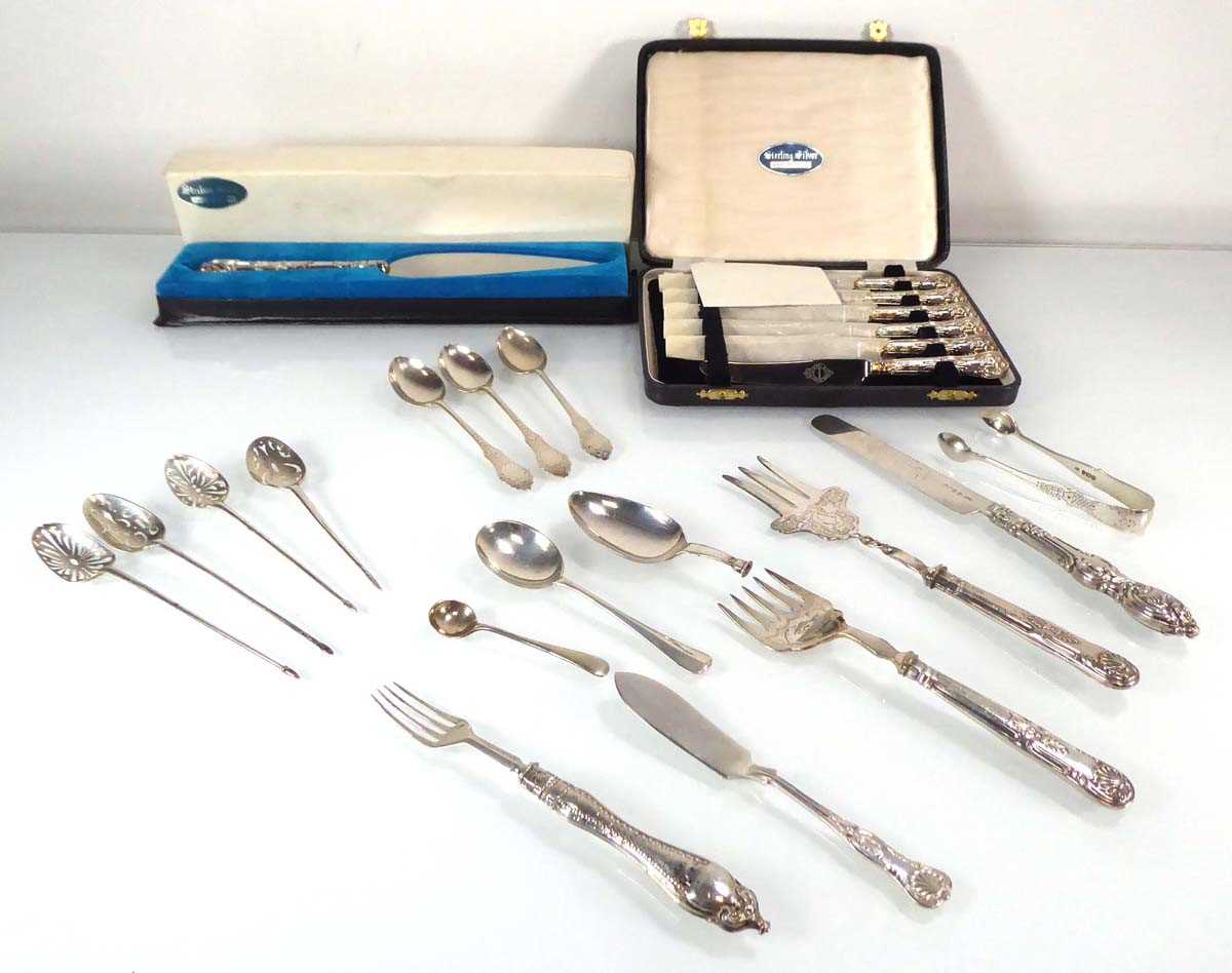 A mixed group of silver flatware comprising a cased set of six butter knives, a cake slice, three