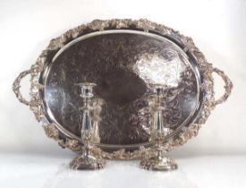 A large silver plated two handled tray of oval form with fruiting vine border, w. 72 cm, together