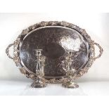 A large silver plated two handled tray of oval form with fruiting vine border, w. 72 cm, together