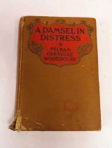 A Damsel in Distress by P G Wodehouse (1st edition, George H Doran, 1919). No dustcover. Some wear