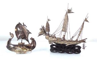 A metalware model of a Chinese junk on a hardwood stand, h. 19 cm, together with a further metalware