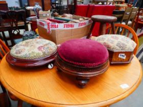 A group of three Victorian embroidered foot stools including one containing a ceramic warmer and