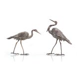 A pair of metalware figures, each modelled as a standing heron, max h. 16 cm, 4 ozs (2) Slightly