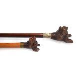 Two early 20th century walking sticks, each with a figural handle modelled as a dog, one with an