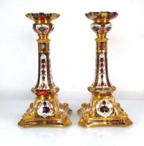 A pair of Royal Crown Derby candlesticks decorated in the 1128 pattern, h. 26 cm (2) Blue ground