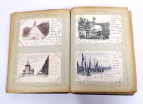 Large leatherbound album containing array of worldwide postcards primarily from 1899-1902, with some