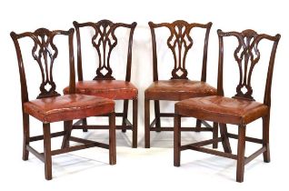 A set of four mahogany Hepplewhite-style dining chairs with leather serpentine seats *Provenance: