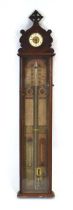 An Admiral Fitzroy barometer surmounted by a timepiece in a mahogany case, h. 124 cm