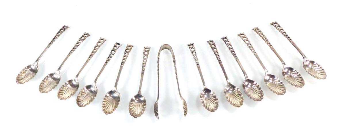 A set of twelve Edwardian silver shell bowl teaspoons and a pair of matching sugar nips, maker HA,