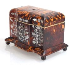 A Georgian tortoise-shell, mother-of-pearl inlaid and ivory mounted caddy of serpentine form, on bun