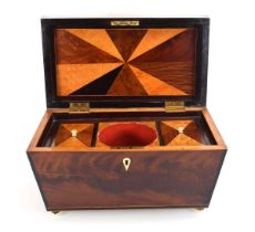 A 19th century mahogany and satinwood strung tea caddy of sarcophagus form, the interior of the