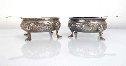 A pair of George II silver salts of oval form, each later decorated with foliate motifs on four