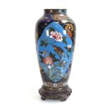 A late 19th century cloisonné two-panelled vase, h. 38 cm, on an associated stand