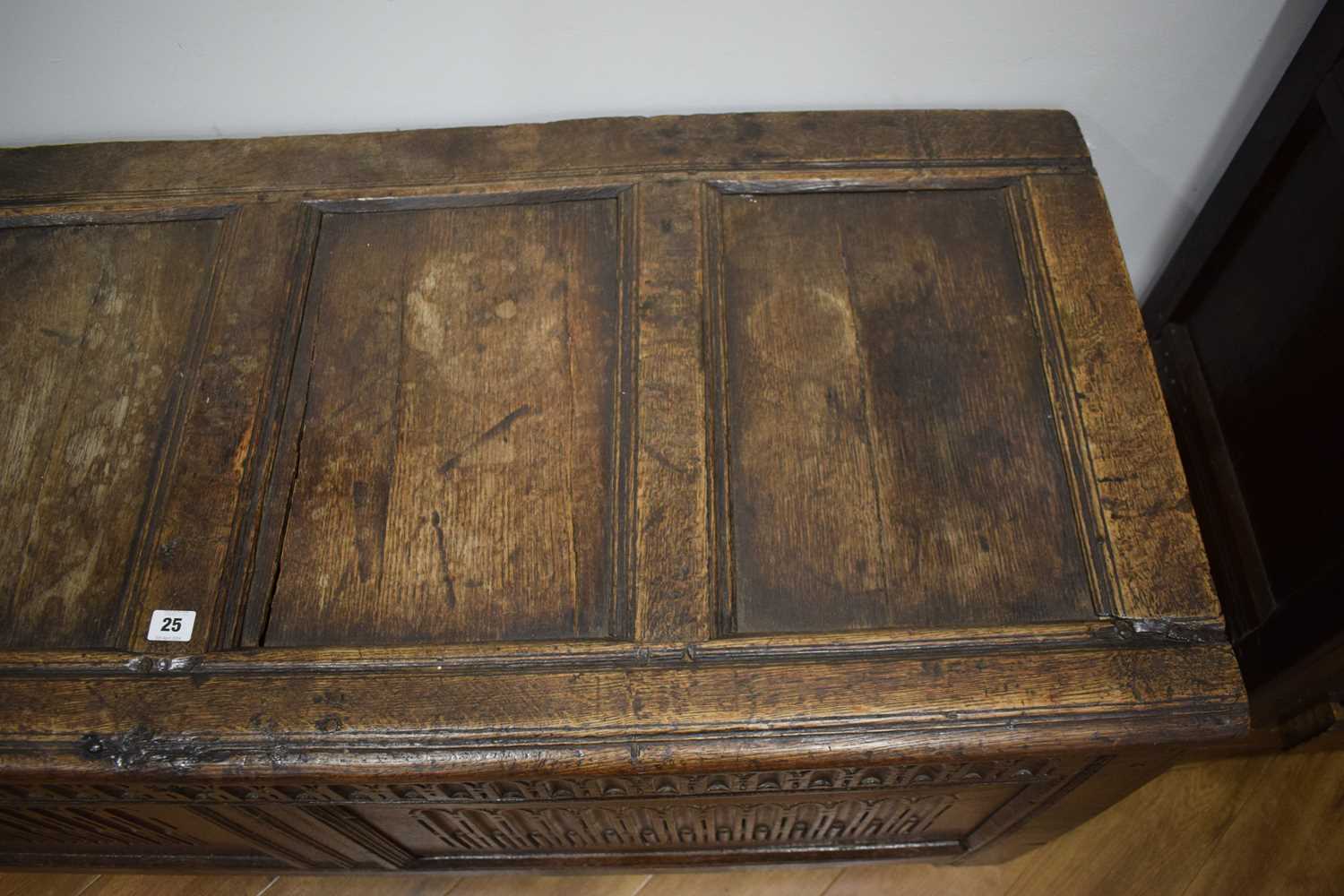 An 18th century oak coffer of long proportions, the four-panelled surface over two later carved - Image 2 of 16