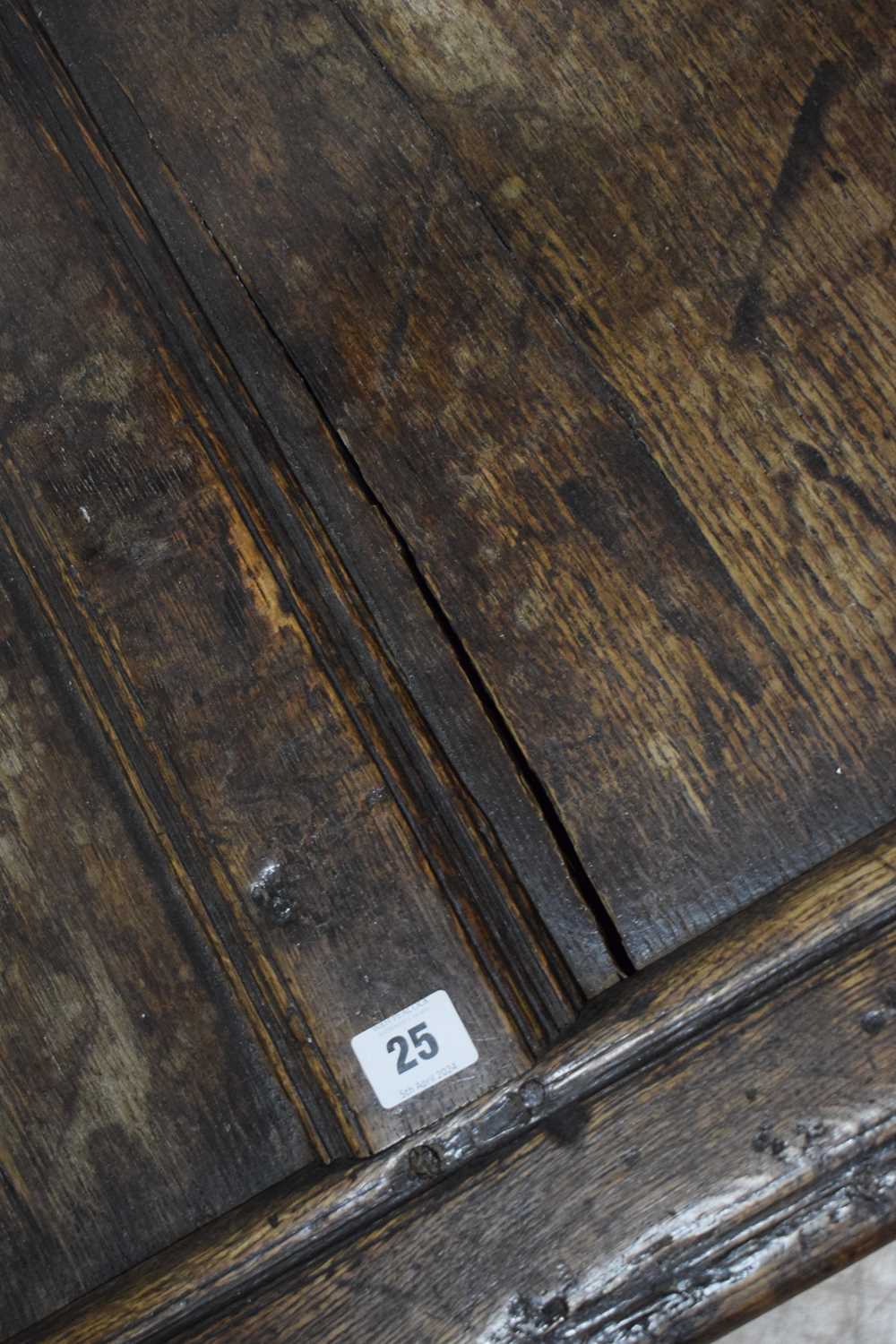 An 18th century oak coffer of long proportions, the four-panelled surface over two later carved - Image 5 of 16