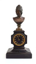 A Victorian clock, the movement striking on a bell, the black marble case surmounted by a spelter