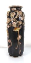 A Royal Doulton stoneware vase of cylindrical form, relief decorated with stylised birds, h. 37.5 vm