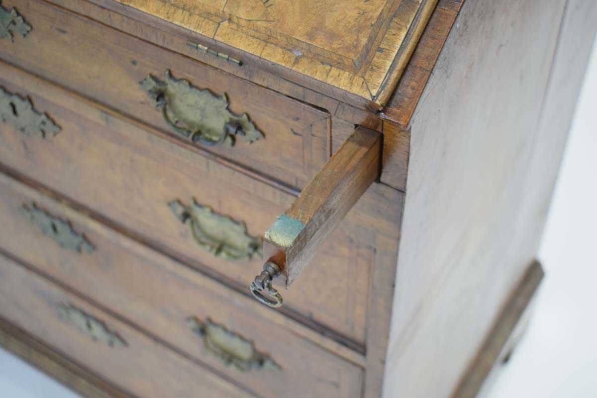 A walnut and feather banded bureau of small proportions, the fall-front over four long graduated - Image 3 of 20