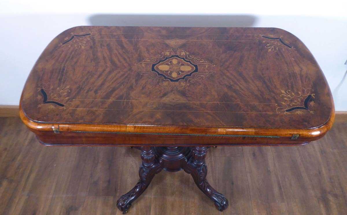 A Victorian figured walnut and marquetry games table on four turned columns and splayed legs with - Image 3 of 5