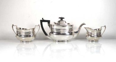 An early 20th century silver three piece tea service of boat shaped form, maker R&S, London 1915,