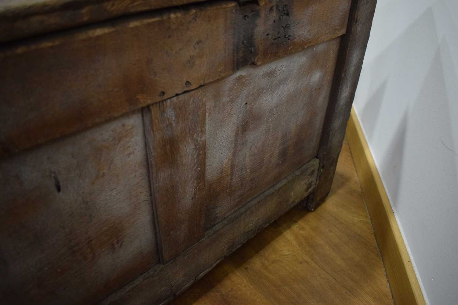 An 18th century oak coffer of long proportions, the four-panelled surface over two later carved - Image 10 of 16