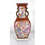 A Chinese Export slab vase decorated in coloured enamels with figures at leisure within a rust