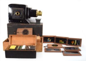 A late 19th/early 20th century magic lantern together with a large collection of glass slides