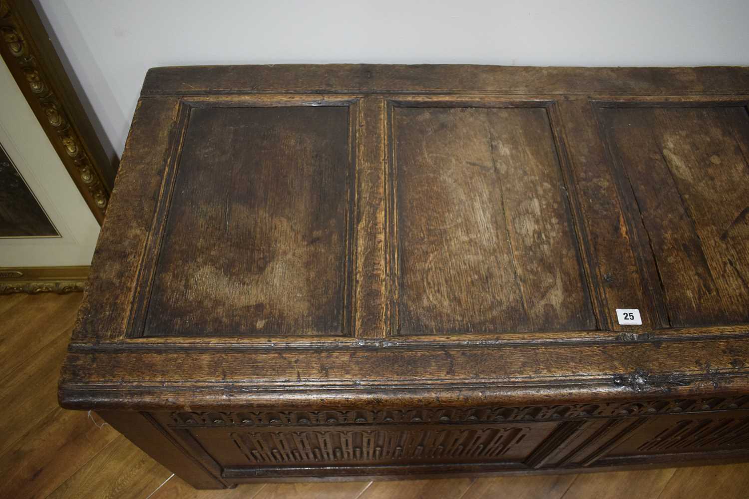 An 18th century oak coffer of long proportions, the four-panelled surface over two later carved - Image 16 of 16