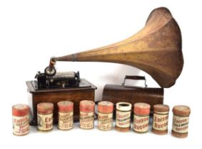 A Thomas Edison standard phonograph with the oak case, tole horn and nine discs, serial 606178