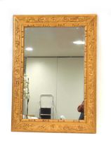 A giltwood wall mirror, the rectangular plate within a foliate frame, 107 x 76 cm Size of mirror