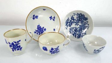 A 19th century tea cup, tea bowl and saucer dish decorated with blue flowers within a gilt border,