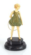 A resin figural modelled as an Art Deco dancer on a stepped plinth, h. 22 cm