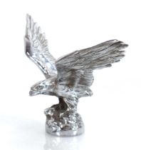 A chromed car hood mascot modelled as an eagle with outstretched arms, w. 23 cm