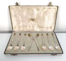 A set of six Danish silver and parcel gilt teaspoons and matching sugar tongs, each with an open