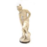 A white parian-type figure modelled as a nude figure washing in a naturalistic setting, h. 85 cm