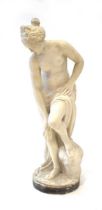 A white parian-type figure modelled as a nude figure washing in a naturalistic setting, h. 85 cm