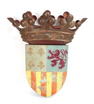 A polychrome cast metal wall plaque modelled as a coat of arms surmounted by a crown, 40 x 34 cm